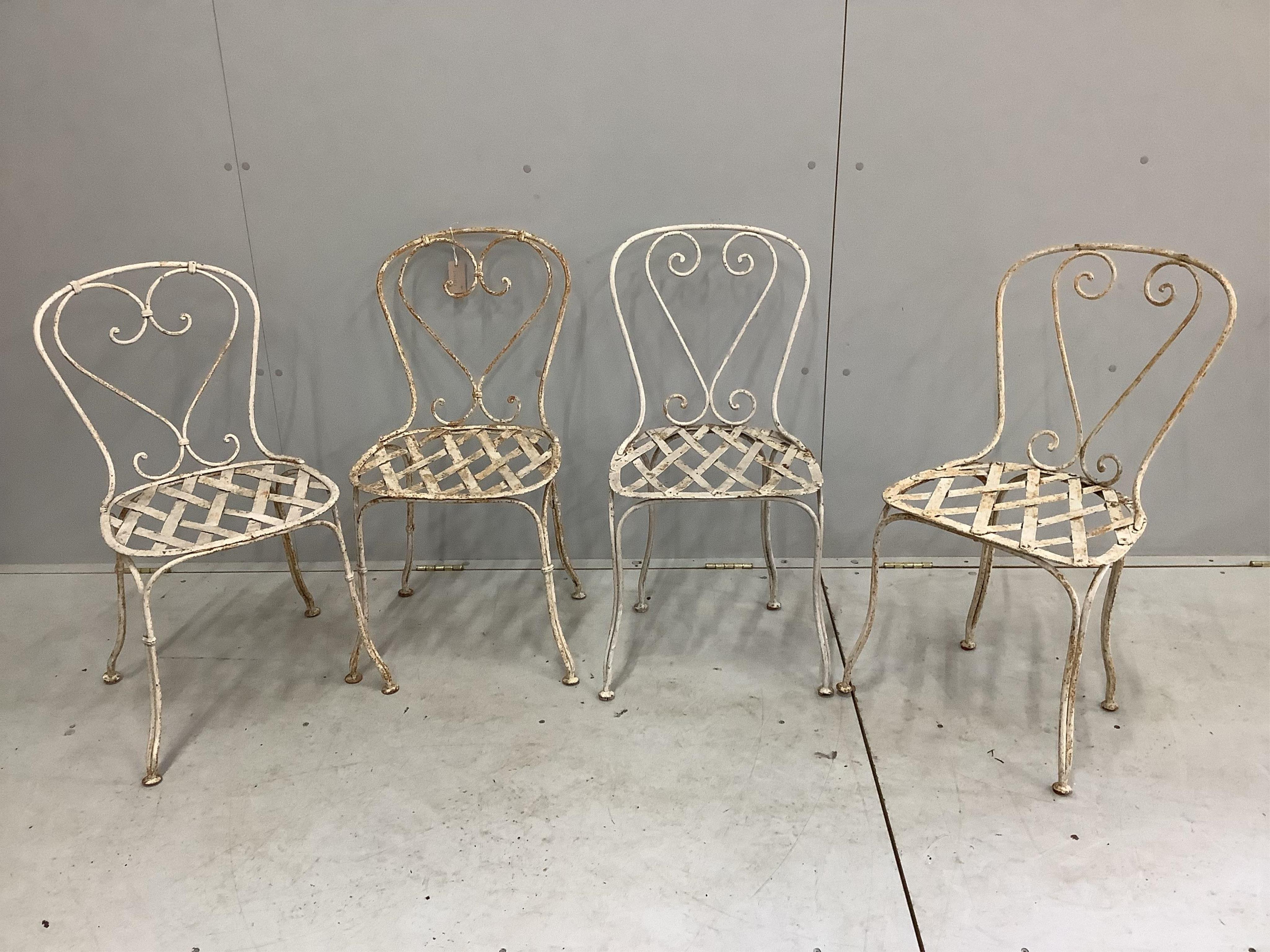 Two pairs of painted wrought iron garden chairs, height 80cm. Condition - oxidised, otherwise fair